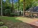 Spacious backyard with mature trees, mulch beds, and a well-maintained lawn at 1105 Tazwell Pl, Raleigh, NC 27612