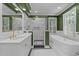 Stylish bathroom with a walk-in shower, white cabinets, a soaking tub and modern fixtures at 1105 Tazwell Pl, Raleigh, NC 27612