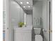 Charming bathroom features light-blue walls, a white vanity and lots of light at 1105 Tazwell Pl, Raleigh, NC 27612