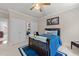 Cozy bedroom with a blue comforter, white carpet, and ample closet space at 1105 Tazwell Pl, Raleigh, NC 27612