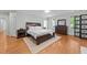 Relaxing bedroom with hardwood floors, a ceiling fan, and a decorative rug under a beautiful bed at 1105 Tazwell Pl, Raleigh, NC 27612