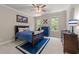 Charming bedroom with a blue comforter and carpet, ample closet space and large windows at 1105 Tazwell Pl, Raleigh, NC 27612
