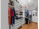 Organized walk-in closet with shelving and rods for hanging clothing and accessories at 1105 Tazwell Pl, Raleigh, NC 27612