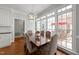 Bright dining area with large windows and stylish chandelier, perfect for entertaining at 1105 Tazwell Pl, Raleigh, NC 27612