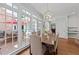 Bright dining area with large windows and stylish chandelier, perfect for entertaining at 1105 Tazwell Pl, Raleigh, NC 27612