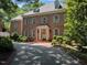 Beautiful brick two-story home featuring manicured landscaping and a welcoming front entrance with wreath at 1105 Tazwell Pl, Raleigh, NC 27612