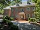 Beautiful brick two-story home featuring manicured landscaping and a welcoming front entrance with wreath at 1105 Tazwell Pl, Raleigh, NC 27612