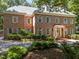 A grand brick home with classic architecture, shutters, and lush landscaping enhancing its elegant appeal at 1105 Tazwell Pl, Raleigh, NC 27612