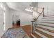 Elegant foyer with hardwood floors, chandelier, and staircase offers a grand entrance and inviting atmosphere at 1105 Tazwell Pl, Raleigh, NC 27612
