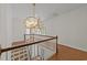 Foyer featuring elegant chandelier, staircase, and hardwood floors at 1105 Tazwell Pl, Raleigh, NC 27612