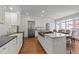 Spacious kitchen with white cabinets, stainless steel appliances and a large center island at 1105 Tazwell Pl, Raleigh, NC 27612