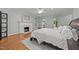 Serene main bedroom featuring a fireplace, hardwood floors, and large windows for natural light at 1105 Tazwell Pl, Raleigh, NC 27612