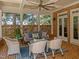 Inviting brick patio with a ceiling fan and comfortable wicker furniture perfect for relaxing outdoors at 1105 Tazwell Pl, Raleigh, NC 27612