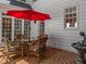 The patio has brick flooring, a red umbrella, and a small water feature that enhances the outdoor ambiance at 1105 Tazwell Pl, Raleigh, NC 27612
