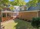 Expansive home featuring multiple brick patios and a sprawling backyard with mature trees at 1105 Tazwell Pl, Raleigh, NC 27612