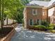 Beautiful home with a side driveway, well-manicured landscaping, and a classic brick exterior at 1105 Tazwell Pl, Raleigh, NC 27612