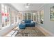 Sun room with natural light and a comfortable blue couch at 1105 Tazwell Pl, Raleigh, NC 27612