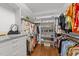 Organized walk-in closet with shelving for shoes, handbags, and hanging clothes at 1105 Tazwell Pl, Raleigh, NC 27612