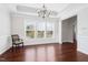 Bright dining room with hardwood flooring, wainscoting, large windows, and modern light fixture creating an elegant space at 1109 Hemby Ridge Ln, Morrisville, NC 27560