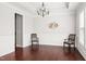 Elegant dining area with hardwood floors, chair rail molding, and a modern chandelier for sophisticated appeal at 1109 Hemby Ridge Ln, Morrisville, NC 27560