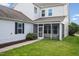 Back of home with a screened in porch, neutral vinyl siding, and green grass at 1109 Hemby Ridge Ln, Morrisville, NC 27560