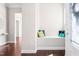 Bright foyer featuring a built-in bench with colorful pillows, hardwood floors, and a view into other rooms at 1109 Hemby Ridge Ln, Morrisville, NC 27560
