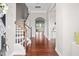 Spacious foyer with hardwood floors, staircase with wooden banister, and arched doorway leading to other rooms at 1109 Hemby Ridge Ln, Morrisville, NC 27560