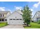 Garage with windows in door and a neatly manicured lawn at 1109 Hemby Ridge Ln, Morrisville, NC 27560