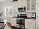 Kitchen features stainless steel appliances, granite counters, and custom white cabinetry at 1109 Hemby Ridge Ln, Morrisville, NC 27560