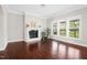 Bright living room featuring hardwood floors, fireplace, and large windows for natural light at 1109 Hemby Ridge Ln, Morrisville, NC 27560