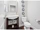 Elegant powder room featuring a pedestal sink, decorative mirrors, and hardwood flooring at 1109 Hemby Ridge Ln, Morrisville, NC 27560