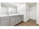Bathroom with a double sink vanity, modern fixtures, and wood-look flooring at 1113 Umstead Grove Way, Durham, NC 27712