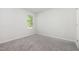 Cozy bedroom with plush carpet, a window overlooking greenery, and ample natural light at 1113 Umstead Grove Way, Durham, NC 27712