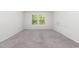 Carpeted bedroom featuring a double window providing natural light and a calming view at 1113 Umstead Grove Way, Durham, NC 27712