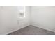 Walk-in closet with wire shelving for storage, a window providing natural light, and neutral carpet at 1113 Umstead Grove Way, Durham, NC 27712