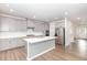 Modern kitchen with grey cabinetry, stainless steel appliances, and a stylish center island at 1113 Umstead Grove Way, Durham, NC 27712
