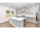 Modern kitchen with grey cabinetry, white countertops, and a spacious center island at 1113 Umstead Grove Way, Durham, NC 27712