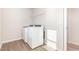 Functional laundry room with white appliances, a wire shelf, and tile flooring at 1113 Umstead Grove Way, Durham, NC 27712