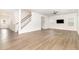 Spacious living room with wood-look floors, stairs to the second floor, and a view of the front door at 1113 Umstead Grove Way, Durham, NC 27712