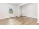 Bright, empty room featuring light wood floors and a sunlit window, ready to be personalized at 1113 Umstead Grove Way, Durham, NC 27712