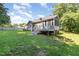 Exterior of home with a spacious backyard, deck, and a well maintained lawn at 112 Avent Pines Ln, Holly Springs, NC 27540