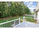 View of the backyard with a deck overlooking the lush, green lawn at 112 Avent Pines Ln, Holly Springs, NC 27540