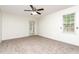 Neutral bedroom with a ceiling fan, exterior door, and a window allowing natural light at 112 Avent Pines Ln, Holly Springs, NC 27540