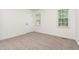 Clean and neutral bedroom with two windows and a white door at 112 Avent Pines Ln, Holly Springs, NC 27540