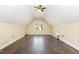 Spacious bonus room offers a window, wood flooring, and recessed lights at 112 Avent Pines Ln, Holly Springs, NC 27540