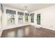 Well-lit dining area with hardwood floors and a door to the outside at 112 Avent Pines Ln, Holly Springs, NC 27540