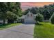 Charming home with a two-car garage, a well-maintained lawn, and mature landscaping at 112 Avent Pines Ln, Holly Springs, NC 27540