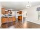 Open kitchen featuring wooden cabinets, a breakfast bar, and hardwood flooring at 112 Avent Pines Ln, Holly Springs, NC 27540