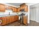 Cozy kitchen featuring stainless steel appliances, warm cabinetry and lots of prep space at 112 Avent Pines Ln, Holly Springs, NC 27540