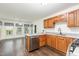 Functional kitchen design with wooden cabinets, laminate countertops, and stainless steel appliances at 112 Avent Pines Ln, Holly Springs, NC 27540